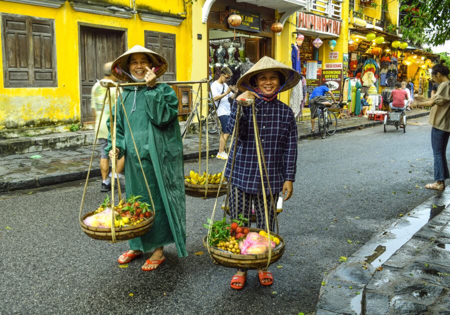 Fruit selling is also a touristy business in Hoi An. Here two locals are seen selling fruits in traditional baskets.